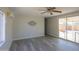 Living room with gray vinyl flooring and sliding door at 192 S Ralston Rd, Maricopa, AZ 85139