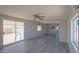 Spacious living room with gray flooring and sliding glass doors at 192 S Ralston Rd, Maricopa, AZ 85139