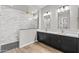 Modern bathroom featuring a double vanity, elegant fixtures, marble shower, and stylish tile at 32480 N 134Th Ln, Peoria, AZ 85383