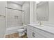 This bathroom features a shower over tub, white shaker cabinets, and brass fixtures at 32480 N 134Th Ln, Peoria, AZ 85383