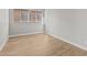 This bedroom features wood look tile flooring and natural light from two windows at 32480 N 134Th Ln, Peoria, AZ 85383