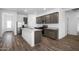 Modern kitchen boasts stainless steel appliances, granite countertops and wood flooring at 24567 W Alta Vista Rd, Buckeye, AZ 85326