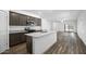Open kitchen includes granite counters, stainless appliances, wood floors, and connects to the living area at 24567 W Alta Vista Rd, Buckeye, AZ 85326