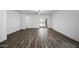 Spacious living room with wood floors and sliding glass door to the backyard at 24567 W Alta Vista Rd, Buckeye, AZ 85326