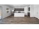 Open kitchen and living space with stainless steel appliances and wood-look flooring at 24668 W Alta Vista Rd, Buckeye, AZ 85326