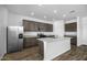 Bright kitchen featuring a large island, stainless steel appliances, and stylish cabinetry at 24668 W Alta Vista Rd, Buckeye, AZ 85326