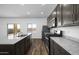 Modern kitchen featuring granite countertops, stainless steel appliances and dark cabinets at 24668 W Alta Vista Rd, Buckeye, AZ 85326