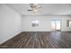 Bright and airy living room with a sliding glass door, natural light, and wood-look floors at 24668 W Alta Vista Rd, Buckeye, AZ 85326