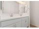 Bright bathroom with double sinks, white cabinets, and a large mirror at 4735 W Stargazer Pl, Laveen, AZ 85339