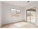Bedroom with wood-look tile flooring and a sliding glass door leading to the backyard at 4735 W Stargazer Pl, Laveen, AZ 85339