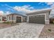 Exterior of the home featuring multiple garage spaces and stone accents at 4735 W Stargazer Pl, Laveen, AZ 85339