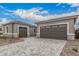 A home's exterior with a stone-accented facade and large garages at 4735 W Stargazer Pl, Laveen, AZ 85339