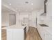 Stylish kitchen with white cabinets, a center island with a sink, and modern appliances at 4735 W Stargazer Pl, Laveen, AZ 85339