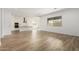 Open-concept living area with wood-look tile flooring, with kitchen in the background at 4735 W Stargazer Pl, Laveen, AZ 85339