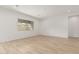 Bright and airy living room with wood-look tile flooring and a large window at 4735 W Stargazer Pl, Laveen, AZ 85339