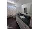 Bathroom with dark vanity and floral shower curtain at 6245 W Southgate St, Phoenix, AZ 85043