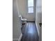 Small bathroom with toilet, vanity, and dark wood-look floors at 6245 W Southgate St, Phoenix, AZ 85043