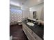 Clean bathroom with granite countertop, shower, and dark wood-look floors at 6245 W Southgate St, Phoenix, AZ 85043