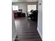 Dining area with dark wood-look floors and a view of the kitchen at 6245 W Southgate St, Phoenix, AZ 85043