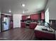 Bright kitchen with stainless steel appliances and dark wood cabinets at 6245 W Southgate St, Phoenix, AZ 85043