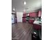 Kitchen with stainless steel appliances and red cabinets at 6245 W Southgate St, Phoenix, AZ 85043
