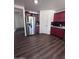 Kitchen features stainless steel refrigerator and red cabinets at 6245 W Southgate St, Phoenix, AZ 85043