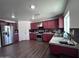 Bright kitchen with stainless steel appliances and dark wood cabinets at 6245 W Southgate St, Phoenix, AZ 85043