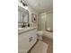 Clean bathroom featuring a granite countertop, updated fixtures, and a shower with glass doors at 7930 E Camelback Rd # 506, Scottsdale, AZ 85251