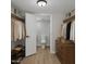 Organized walk-in closet with built-in shelving, drawers, and an ensuite bathroom at 7930 E Camelback Rd # 506, Scottsdale, AZ 85251