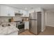 Well-lit kitchen featuring stainless steel appliances, white cabinets, and granite countertops at 7930 E Camelback Rd # 506, Scottsdale, AZ 85251