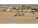 Expansive aerial view of a single-story home on a large lot with outbuildings and desert landscaping at 22352 W Gamble Ln, Wittmann, AZ 85361