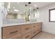 Bathroom vanity showcasing custom wood cabinets, marble countertops, and modern pendant lighting at 6901 E Restin Rd, Carefree, AZ 85377
