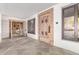Grand entryway featuring custom wood door, natural stone floors, and views into the adjacent living spaces at 6901 E Restin Rd, Carefree, AZ 85377