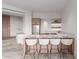 Stylish kitchenette features bar seating, stainless steel appliances, and floating shelves at 6901 E Restin Rd, Carefree, AZ 85377