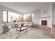 Bright living room with fireplace, comfortable seating, and expansive windows at 6901 E Restin Rd, Carefree, AZ 85377