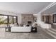Comfortable living area with a stone fireplace, neutral sofa, and views to the outdoor spaces at 6901 E Restin Rd, Carefree, AZ 85377