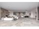 Open-concept living space featuring a stone fireplace, dining area, and entryway with custom doors at 6901 E Restin Rd, Carefree, AZ 85377
