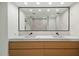 Modern bathroom features double sinks, floating vanity, a sleek mirror, and light tile at 7127 E Rancho Vista Dr # 4001, Scottsdale, AZ 85251