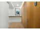 Hallway view with light wood floors, artwork, and a modern wall panel at 7127 E Rancho Vista Dr # 4001, Scottsdale, AZ 85251