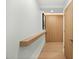 Hallway with wood shelf, white walls, and a door at the end at 7127 E Rancho Vista Dr # 4001, Scottsdale, AZ 85251