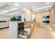 Contemporary kitchen featuring light wood cabinets, stainless steel appliances, and an open dishwasher at 7127 E Rancho Vista Dr # 4001, Scottsdale, AZ 85251