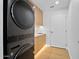 Modern laundry room featuring a stacked washer/dryer, sleek cabinetry, and ample counter space at 7127 E Rancho Vista Dr # 4001, Scottsdale, AZ 85251