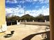 Relaxing back patio with desert landscaping, a decorative wall and scenic mountain views at 44421 N 20Th St, New River, AZ 85087