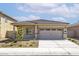 Charming single-story home with neutral paint, two-car garage and beautifully landscaped front yard at 24621 W Alta Vista Rd, Buckeye, AZ 85326