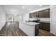 Open-concept kitchen with island, stainless steel appliances, granite counters, flowing into the living area at 24621 W Alta Vista Rd, Buckeye, AZ 85326