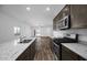 Open-concept kitchen with island, stainless steel appliances, granite counters, flowing into the living area at 24621 W Alta Vista Rd, Buckeye, AZ 85326