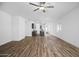 Open living room with ceiling fan, modern flooring, and ample space for entertaining at 24621 W Alta Vista Rd, Buckeye, AZ 85326