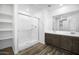 Bright bathroom featuring a glass shower, modern vanity with double sinks, and open shelving at 6486 S 246Th Ln, Buckeye, AZ 85326