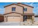 Inviting two-story home featuring a two-car garage, desert landscaping, and a stylish, covered front entry at 6486 S 246Th Ln, Buckeye, AZ 85326