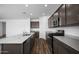 Spacious kitchen showcases dark cabinets, granite counters, stainless appliances, and recessed lighting at 6486 S 246Th Ln, Buckeye, AZ 85326